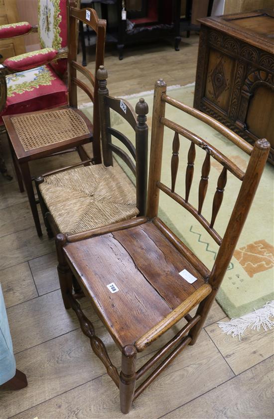 A wood seat spindle back chair and two other chairs